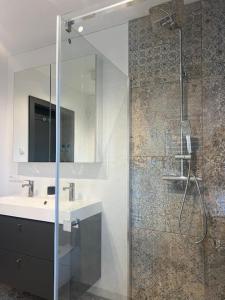 a bathroom with a shower and a sink and a mirror at Modern house in Gorczyn in Górczyn