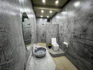 a bathroom with a sink and a shower and a toilet at Happiness Kulambo Villa El Nido in El Nido