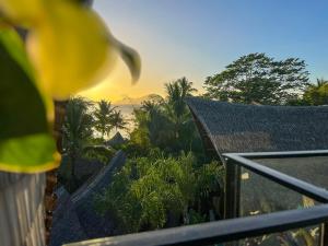 a view of the ocean from a balcony of a house at Happiness Kulambo Villa El Nido in El Nido