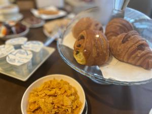 a table with a plate of different types of pastries at B&B Cavour16 in Genoa
