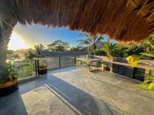 a balcony with a table and a view of the ocean at Happiness Kulambo Villa El Nido in El Nido