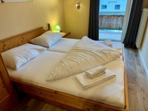 a large white bed with two pillows on it at Familienurlaub mit Baden & Berge, FeWo 2 in Thiersee