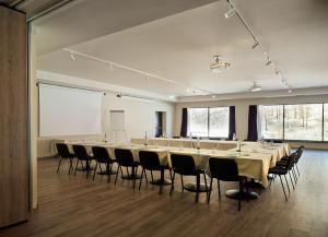 a large conference room with a long table and chairs at Cervino - VRetreats in Breuil-Cervinia +37 photos