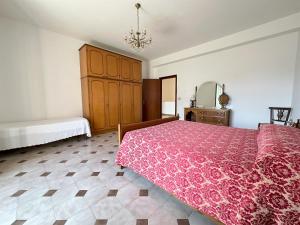 ein Schlafzimmer mit einem rosa Bett und einer Kommode in der Unterkunft Villa Chris in Taormina