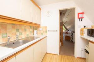 a kitchen with a sink and a microwave at Chalet 98 in Deal