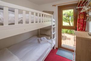 a bedroom with a bunk bed and a window at Chalet 98 in Deal