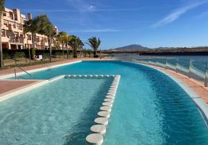 a swimming pool with rocks in the water at Condado de Alhama, LA ISLA 80H in El Romero