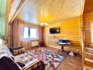 a room with a couch and a table in a room at Сакский Двор in Besqaynar