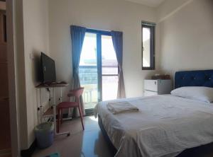 Uma cama ou camas num quarto em Dahu Yipinyuan B&B