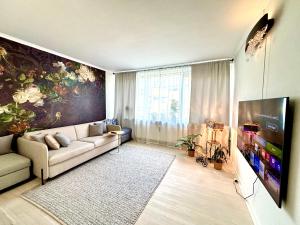 a living room with a couch and a painting on the wall at Luxurious Boutique Apartment, inner city, next to Canals and Metro station in Copenhagen