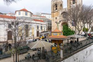 a building with a food cart in a city at Portas da Sé Apartments in Lisbon