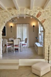 a dining room with a table and chairs at Olive House Traditional Villa with Pool in Sitia