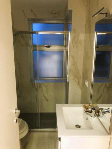 a bathroom with a sink and a shower with a window at Hotel Amalfi & Dépendance in Lignano Sabbiadoro