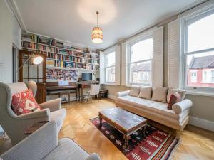 a living room with a couch and a table at Pass the Keys Stylish London Flat near Station - Victoria 20 min in London