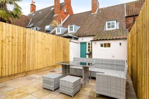 a patio with a table and chairs and a fence at 32 Bailgate, Lincoln in Lincolnshire