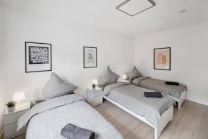 two beds in a bedroom with white walls at Nice Apartments in Hanau in Hanau am Main