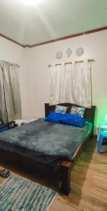 a bedroom with a large bed with blue sheets at Puerto Galera Transient Guest Room in Puerto Galera