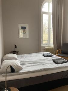 a bed in a bedroom with a window at Hellidens Slott in Tidaholm