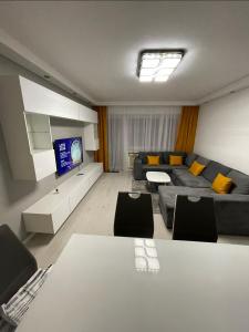 a living room with a couch and a tv at Best Apartment Augsburg in Augsburg