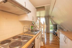 a kitchen with a stove and a sink at Chalet 106 in Deal