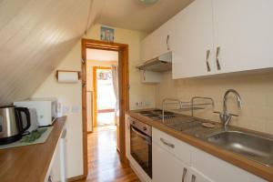 a kitchen with a sink and a stove top oven at Chalet 106 in Deal +13 photos