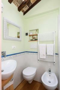 a bathroom with a white toilet and a sink at Casa Mia A Cortona in Cortona