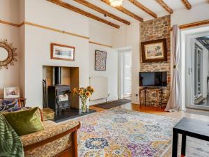 a living room with a couch and a fireplace at Pass the Keys Beautiful Sea View House in Borth