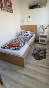 a bedroom with a bed with a wooden headboard at Fogarasi - Relax Island in Budapest