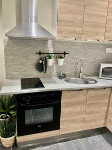 a kitchen with a sink and a stove at Studi'o Lubéron in Cavaillon