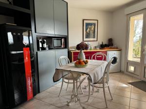 a kitchen with a table with a bowl of fruit on it at Logement entier de charme, gite équestre GERS Flamarens in Flamarens