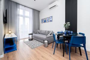 a living room with a table and a couch at Apartament Indygo16 in Kalisz