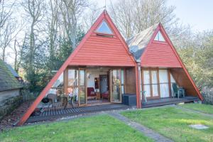 a small house with a red roof at Chalet 134 in Deal