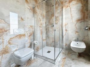 a bathroom with a shower and a toilet and a sink at Pepe's Home B&B in Nichelino