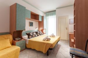 une chambre d'hôtel avec un lit et un canapé dans l'établissement Hotel Atlantic, à Gatteo a Mare