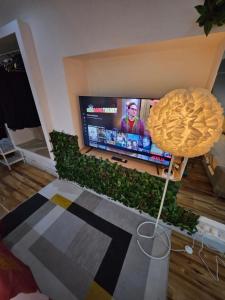 a living room with a television and a table at AMAZING OPEN PLAN LIVING in Manchester