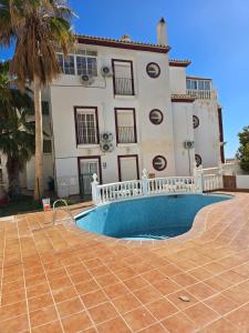 a house with a swimming pool in front of it at Hotel Betania in Benalmádena
