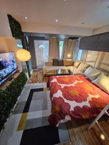 a bedroom with a bed and a living room at AMAZING OPEN PLAN LIVING in Manchester