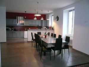 a kitchen and dining room with a table and chairs at Gîte le chant des tournesols piscine chauffée in Montirat