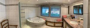 a bathroom with a tub and a toilet and a sink at Ferme alsacienne in Soppe-le-Haut