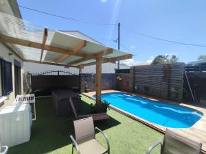 a patio with a swimming pool and a pergola at Chez Fred Saint André in Saint-André