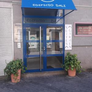 a telephone booth with two potted plants in front of it at Suites Garden Apartamento 33 in Las Palmas de Gran Canaria