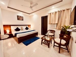 1 dormitorio con 1 cama, mesa y sillas en The Pacific Grand Haridwar en Haridwār
