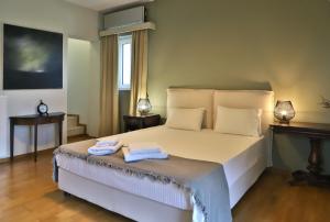 a bedroom with a bed with two towels on it at Olive House Traditional Villa with Pool in Sitia +28 photos