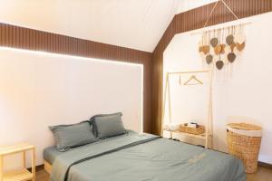 a bedroom with a bed and a large window at The Homilá Bảo Lộc - Hill View Bungalow & Glamping in Bao Loc