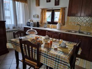 a kitchen with a table with food on it at Casa Oliena in Oliena