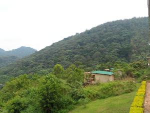 une petite maison au milieu d'une montagne dans l'établissement Buhoma Community Haven lodge, 