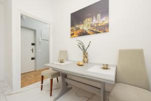 a white desk in a room with a painting on the wall at Royal Castle View Warsaw by Renters in Warszawa