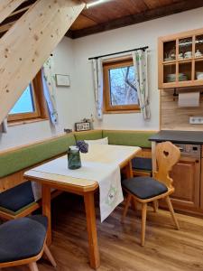 a kitchen and dining room with a table and chairs at Leitnerbauer's Troadkasten in Donnersbach