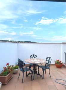 een patio tafel en stoelen op een balkon bij Casa Mar, with parking and ideal for families in Sant Feliu de Guixols