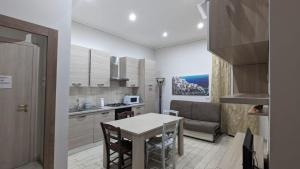 a kitchen and dining room with a table and a couch at O'Presidente B&B in Gragnano